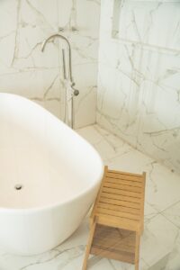 a bathtub and a chair in a bathroom